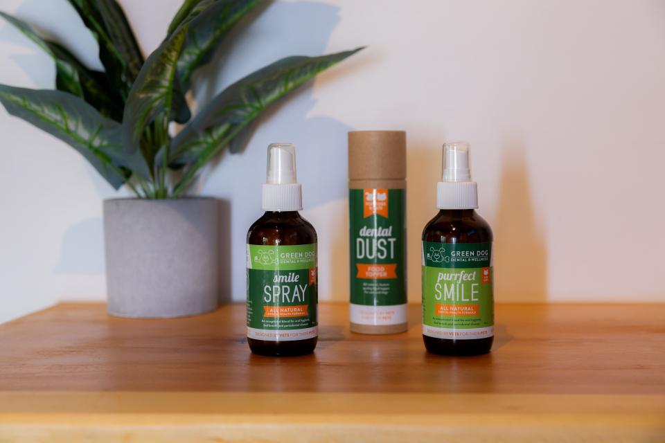 Green Dog branded dental products including Smile Spray, Dental Dust, and Purrfect Smile displayed on a wooden shelf in Sherman Oaks